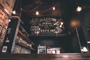 Modern café interior with artistic chalkboard, cozy vibes, and ambient lighting.